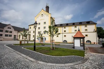 a large white building with a gazebo in front of it at Hotel U Lípy in Krušovice
