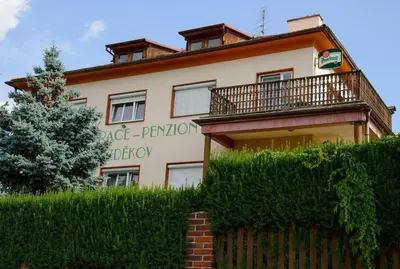 a building with a fence in front of it at Penzion Bezděkov in Rakovník