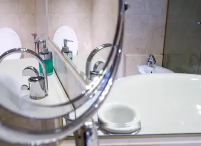 a bathroom with two sinks and a mirror at Karlova - Old Town Apartment in Prague