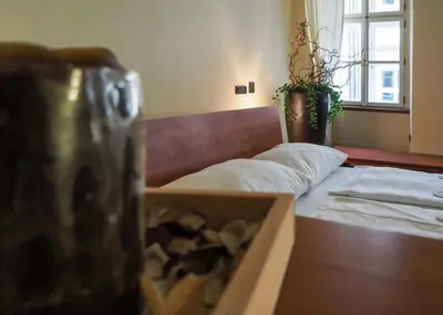 a bedroom with a bed and a box at Karlova - Old Town Apartment in Prague