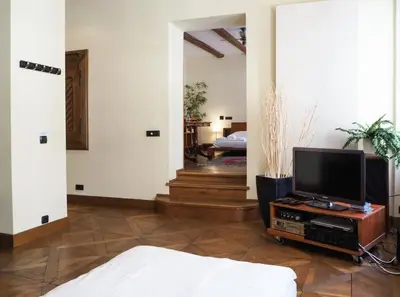 a living room with a tv on a table at Karlova - Old Town Apartment in Prague