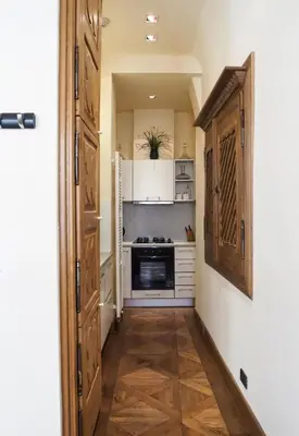 a hallway with a kitchen with a stove at Karlova - Old Town Apartment in Prague