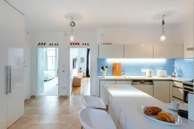 a kitchen with a counter with a plate of food on it at *SUNNY and STYLISH* Apt with BALCONY near TV Tower in Prague