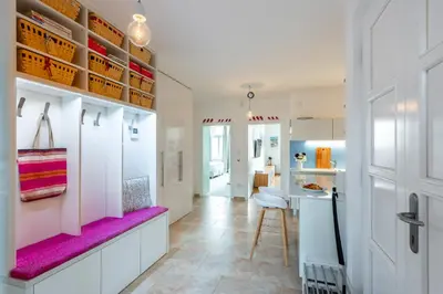 a kitchen with white cabinets and a purple bench at *SUNNY and STYLISH* Apt with BALCONY near TV Tower in Prague