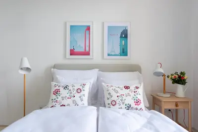 a bedroom with two beds and two pictures on the wall at *SUNNY and STYLISH* Apt with BALCONY near TV Tower in Prague