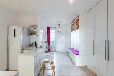 a kitchen with white cabinets and a white refrigerator at *SUNNY and STYLISH* Apt with BALCONY near TV Tower in Prague