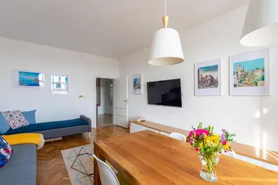 a living room with a vase of flowers on a table at *SUNNY and STYLISH* Apt with BALCONY near TV Tower in Prague