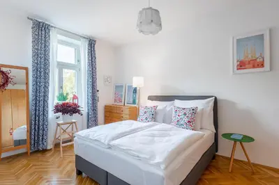 a bedroom with a bed with white sheets and pillows at *SUNNY and STYLISH* Apt with BALCONY near TV Tower in Prague