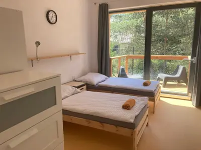 a room with two beds and a large window at KuK Račice in Račice