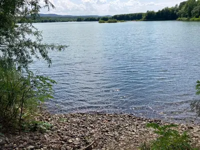 a large body of water with a rocky shore at KuK Račice in Račice