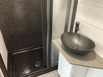 a bathroom with a sink and a shower at KuK Račice - pokoj s malou terasou in Račice