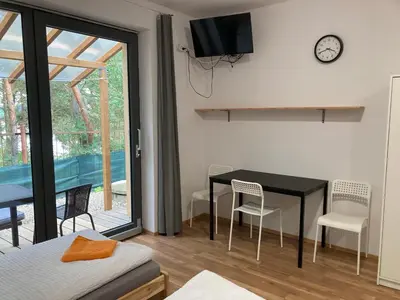 a room with a table and chairs and a window at KuK Račice - pokoj s malou terasou in Račice