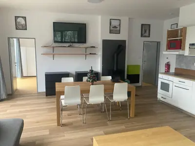 a kitchen and dining room with a table and chairs at KuK Račice - 4 loznice in Račice