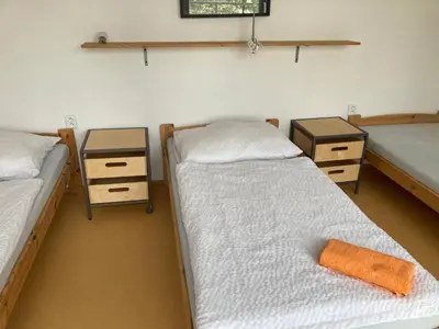 a room with two beds and two night stands at KuK Račice - 4 loznice in Račice