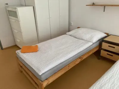 a small bed in a room with a dresser at KuK Račice - 4 loznice in Račice