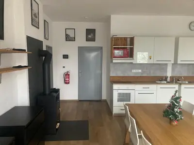 a kitchen with white cabinets and a christmas tree in it at KuK Račice - 4 loznice in Račice