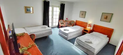 a living room with two couches and a table at Hotel Magnolia in Roudnice nad Labem