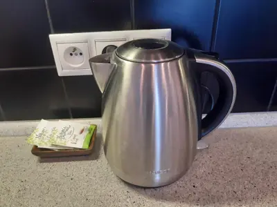 a tea kettle sitting on a counter next to an electrical outlet at Apartment Park Radouč - 60m2 in Mladá Boleslav