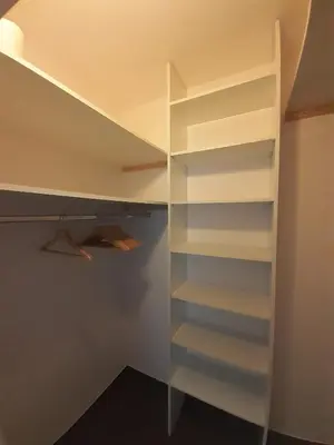 a walk in closet with white shelves at Apartment Park Radouč - 60m2 in Mladá Boleslav