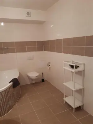 a bathroom with a tub and a toilet and a sink at Apartment Park Radouč - 60m2 in Mladá Boleslav