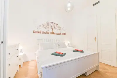 a white bedroom with a white bed with two pillows on it at Brand New Apartment next to Old Town Square in Prague