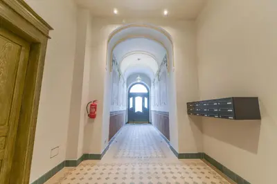 an empty hallway with a door and a tile floor at Brand New Apartment next to Old Town Square in Prague