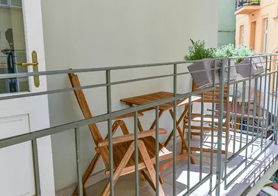 a balcony with a table and a potted plant at Brand New Apartment next to Old Town Square in Prague
