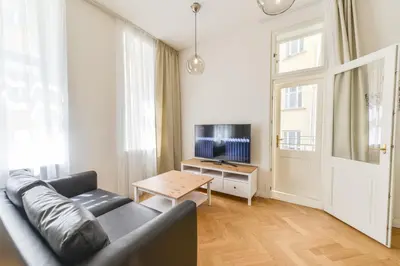 a living room with a couch and a table at Brand New Apartment next to Old Town Square in Prague