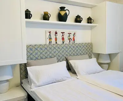 two beds in a room with shelves and vases at Penzion Kokorin Forest Villa in Konrádov