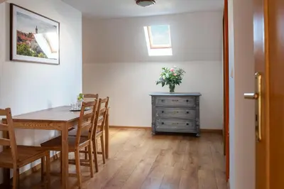 a dining room with a table and chairs and a dresser at Dobrý Kanec - Hostinec in Mělník