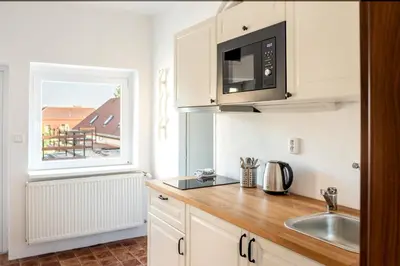 a kitchen with a sink and a microwave at Dobrý Kanec - Hostinec in Mělník