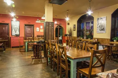 a dining room with wooden tables and chairs at Penzion Zlaté Slunce in Chocenice