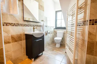 a bathroom with a sink and a toilet at Penzion Zlaté Slunce in Chocenice