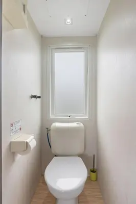 a bathroom with a white toilet and a window at Holiday Home Prima Plus by Interhome in Prague