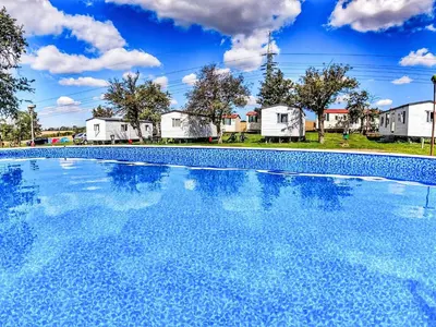 a large swimming pool with houses in the background at Holiday Home Prima Plus by Interhome in Prague