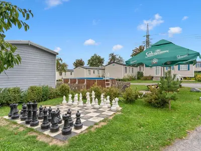 a chess board on a lawn with an umbrella at Holiday Home Prima Plus by Interhome in Prague