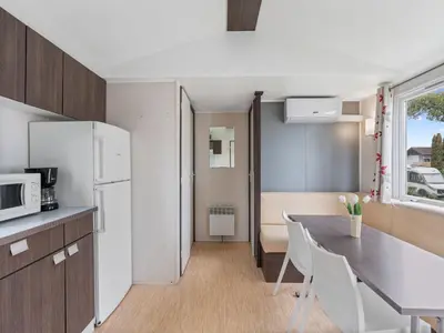 a small kitchen with a table and a refrigerator at Holiday Home Prima Plus by Interhome in Prague