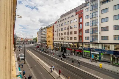 a city street with buildings and people walking on the street at APT in center Prague by Michal&Friends in Prague