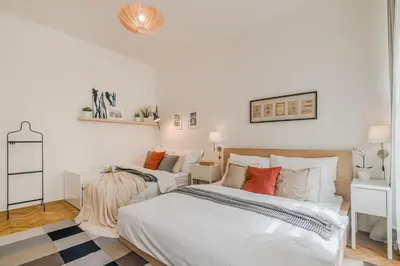 a white bedroom with two beds with pillows at APT in center Prague by Michal&Friends in Prague