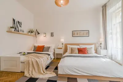 two beds in a room with white walls at APT in center Prague by Michal&Friends in Prague
