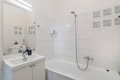 a white bathroom with a tub and a sink at APT in center Prague by Michal&Friends in Prague
