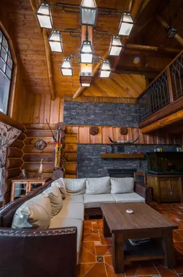 a living room with a couch and a table at Ranch Jestřebice in Heřmaničky