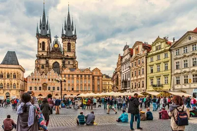 a crowd of people walking around a city with a clock tower at APT IN CENTER Prague Great view by Michal&Friends in Prague