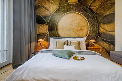 a bedroom with a large bed with a stone wall at APT IN CENTER Prague Great view by Michal&Friends in Prague