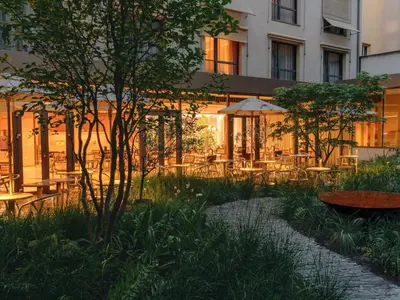 a courtyard with tables and chairs in front of a building at Hotel Josef in Prague