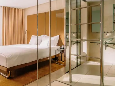 a bedroom with a bed and a glass shower at Hotel Josef in Prague