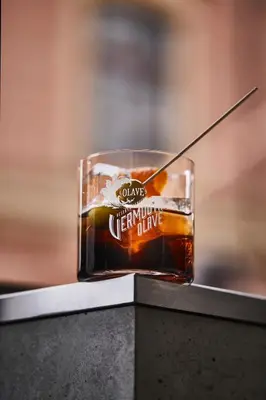 a drink in a glass sitting on a table at Hotel Josef in Prague