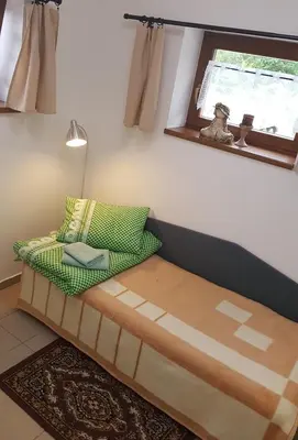 a couch sitting in a room with a window at Na samotě u lesa -Rasovna in Mšecké Žehrovice