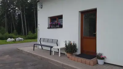 a bench sitting outside of a house with a door at Na samotě u lesa -Rasovna in Mšecké Žehrovice