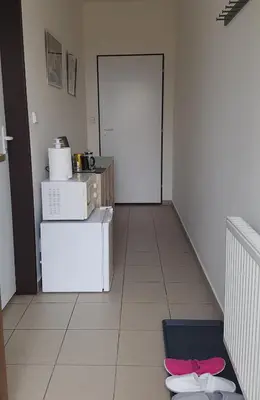 a kitchen with a white refrigerator and a door at Na samotě u lesa -Rasovna in Mšecké Žehrovice